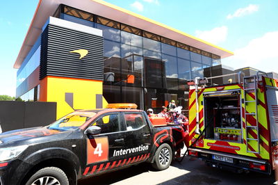 A fire in the McLaren motorhome is tended to by fire fighters. Formula 1 World Championship, Rd 10, Spanish Grand Prix,