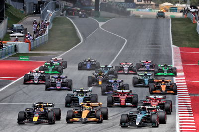 George Russell (GBR) Mercedes AMG F1 W15 leads Lando Norris (GBR) McLaren MCL38 and Max Verstappen (NLD) Red Bull Racing