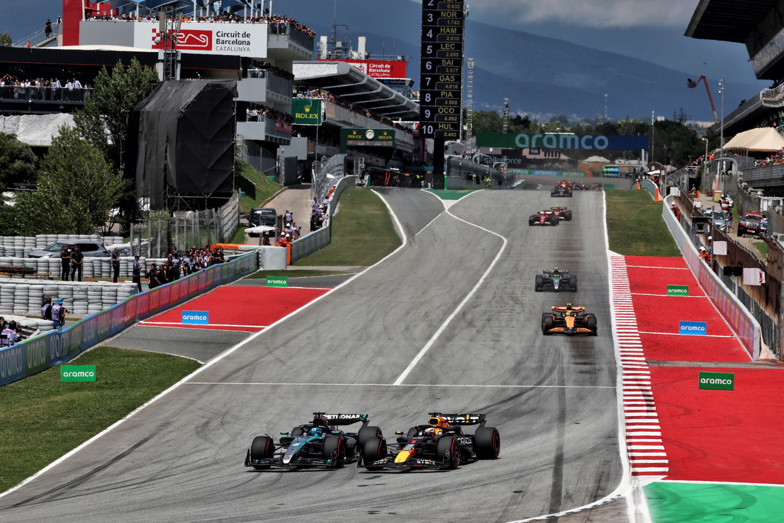 George Russell (GBR) Mercedes AMG F1 W15 loses the lead to Max Verstappen (NLD) Red Bull Racing RB20. Formula 1 World