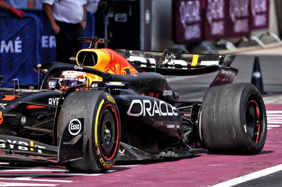 Max Verstappen (NLD) Red Bull Racing RB20 makes a pit stop with a puncture after collision with Lando Norris (GBR) McLaren