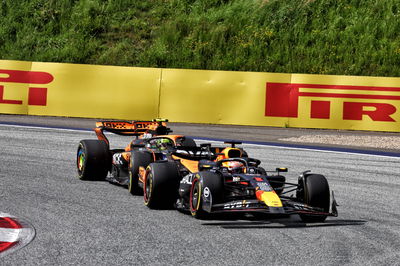 Max Verstappen (NLD) Red Bull Racing RB20 leads Lando Norris (GBR) McLaren MCL38, both with punctures after colliding.