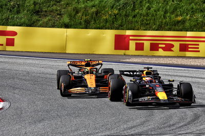 Max Verstappen (NLD) Red Bull Racing RB20 leads Lando Norris (GBR) McLaren MCL38, both with punctures after colliding.