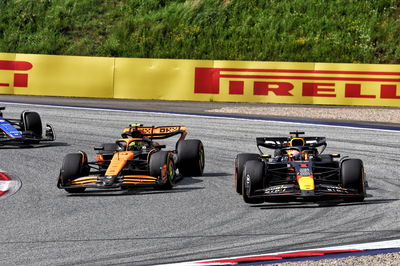 Max Verstappen (NLD) Red Bull Racing RB20 leads Lando Norris (GBR) McLaren MCL38, both with punctures after colliding.