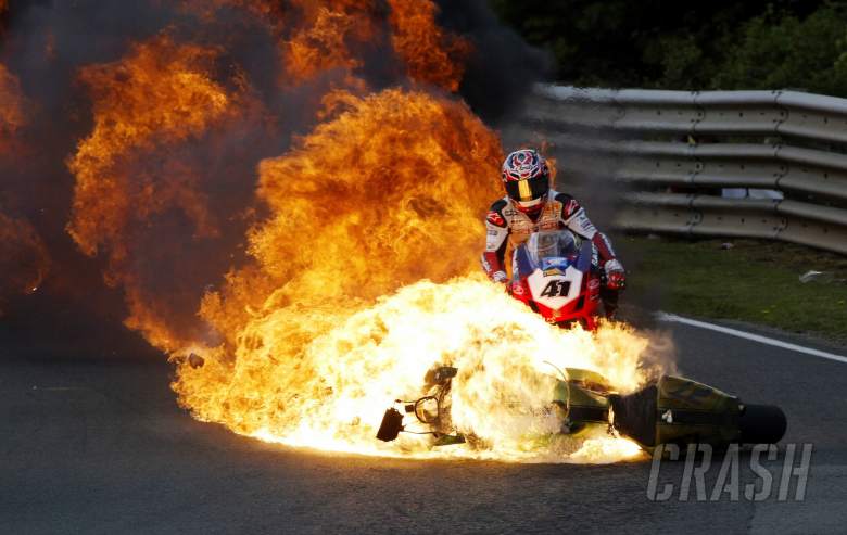 Vince Whittle`s bike on fire as Noriyuki Haga takes evasive action. All riders were ok.