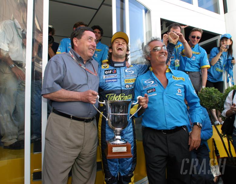 Jarno Trulli celebrates his first F1 grand prix win with Renault`s Patrick Faure and team principal 