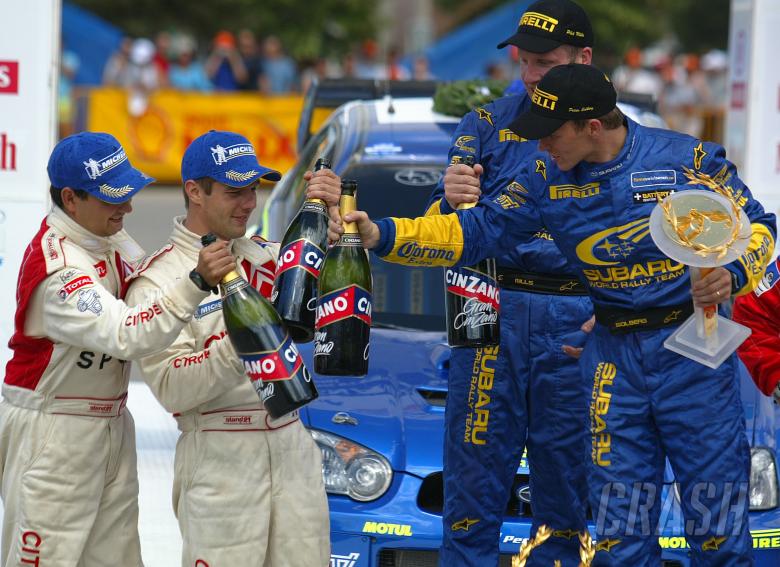 Acropolis Rally winners Petter Solberg and Phil Mills on the podium with Sebastian Loeb and Daniel E