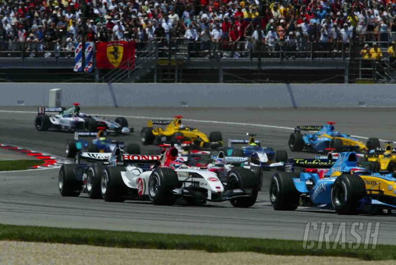 Takuma Sato heads into turn two at Indianapolis at the start of the 2004 USGP