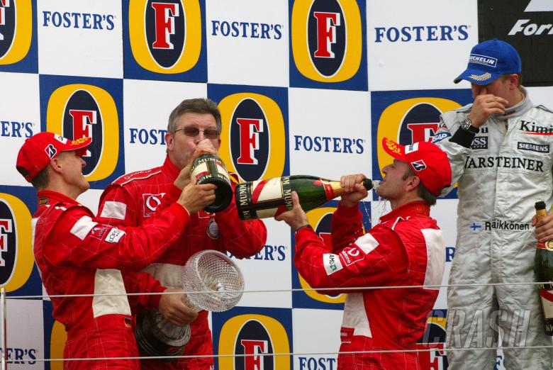 British GP winner, Michael Schumacher on the podium with Kimi Raikkonen [2nd], Rubens Barrichello [3