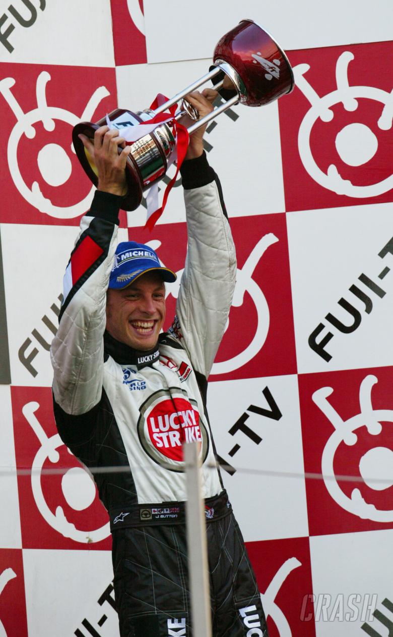 Jenson Button celebrates his tenth podium of the year, after taking third place at the 2004 Japanese