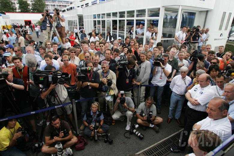 The Michelin team bosses and Bernie Ecclestone hold a press conference outside Michelin`s motorhome 
