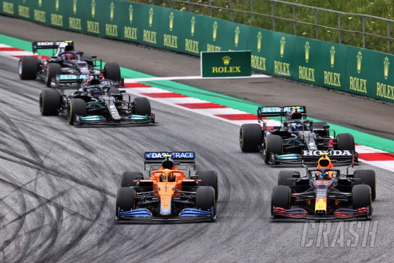 Lando Norris (GBR) McLaren MCL35M and Sergio Perez (MEX) Red Bull Racing RB16B battle for position.