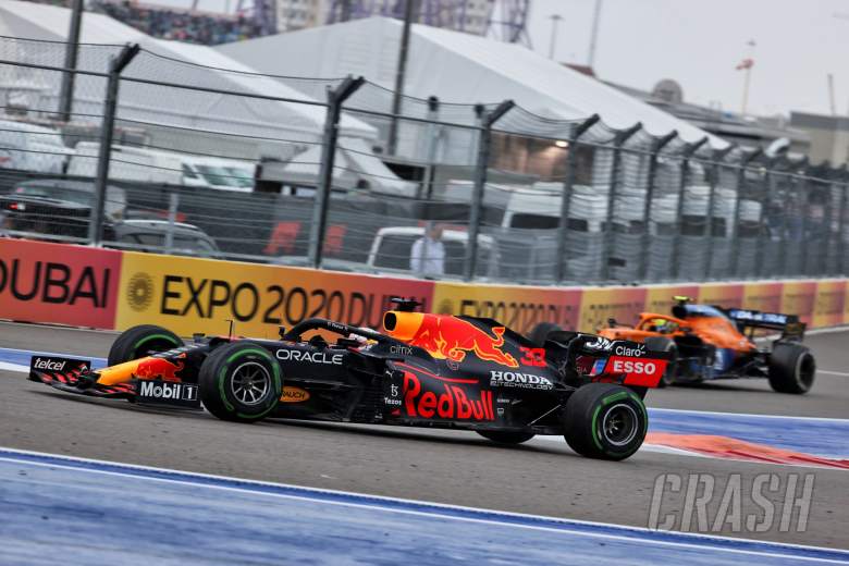 Lando Norris (GBR) McLaren MCL35M heads into the pits as Max Verstappen (NLD) Red Bull Racing RB16B passes him.