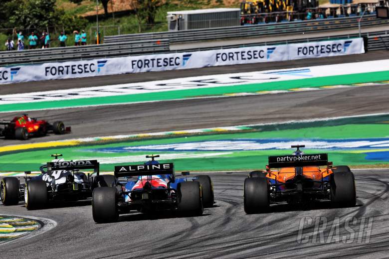 Esteban Ocon (FRA) Alpine F1 Team A521 and Daniel Ricciardo (AUS) McLaren MCL35M battle for position.