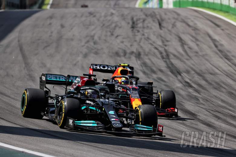 (L to R): Lewis Hamilton (GBR) Mercedes AMG F1 W12 and Sergio Perez (MEX) Red Bull Racing RB16B battle for position.