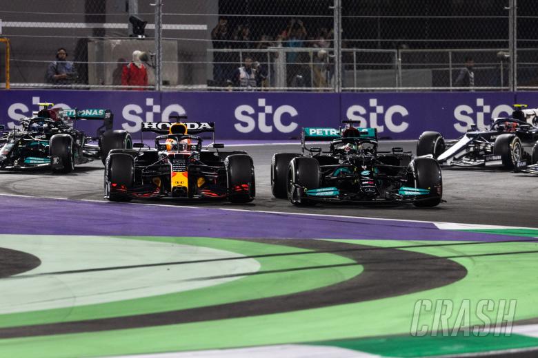 Lewis Hamilton (GBR) Mercedes AMG F1 W12 and Max Verstappen (NLD) Red Bull Racing RB16B battle for the lead at the first race restart.