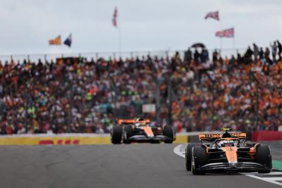 Lando Norris and Oscar Piastri driving for McLaren at the 2023 British Grand Prix.