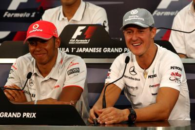 Lewis Hamilton and Michael Schumacher at the 2010 Japanese Grand Prix.