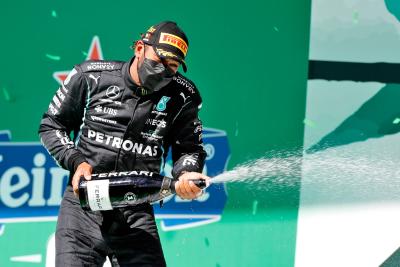 Race winner Lewis Hamilton (GBR) Mercedes AMG F1 celebrates on the podium.