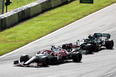 Kimi Raikkonen (FIN) Alfa Romeo Racing C41 and Sebastian Vettel (GER) Aston Martin F1 Team AMR21 battle for position.