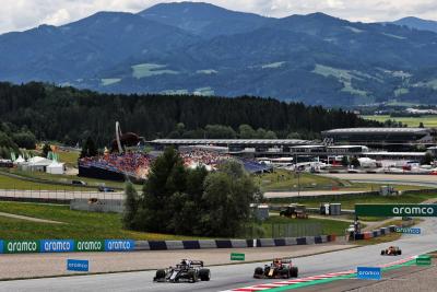 Yuki Tsunoda (JPN) AlphaTauri AT02 and Max Verstappen (NLD) Red Bull Racing RB16B.