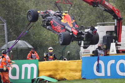 The Red Bull Racing RB16B of Sergio Perez (MEX) is craned away from the circuit after he crashed heading to the grid.