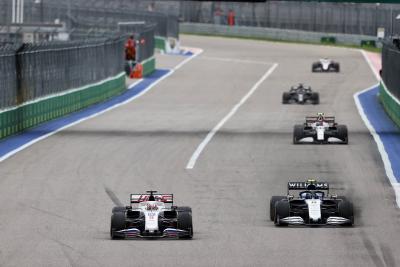 Nikita Mazepin (RUS) Haas F1 Team VF-21 and Nicholas Latifi (CDN) Williams Racing FW43B battle for position.