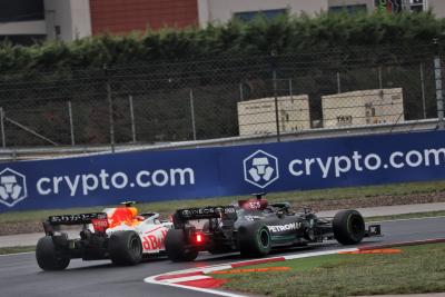 Lewis Hamilton (GBR) Mercedes AMG F1 W12 and Sergio Perez (MEX) Red Bull Racing RB16B battle for position.