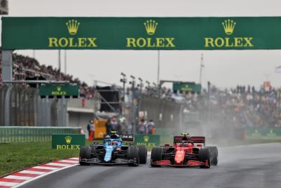 Esteban Ocon (FRA) Alpine F1 Team A521 and Carlos Sainz Jr (ESP) Ferrari SF-21 battle for position.