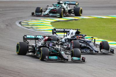 Lewis Hamilton (GBR) Mercedes AMG F1 W12 and Yuki Tsunoda (JPN) AlphaTauri AT02 battle for position.