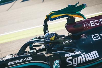 Race winner Lewis Hamilton (GBR) Mercedes AMG F1 W12 celebrates carrying the Brazilian flag at the end of the race.