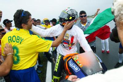 Rossi rides the storm to fourth world title.