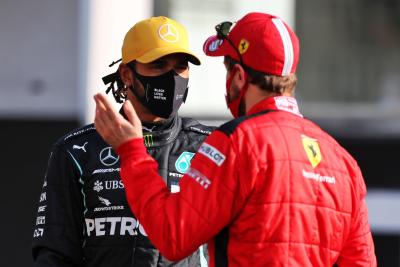 (L to R): Lewis Hamilton (GBR) Mercedes AMG F1 with Sebastian Vettel (GER)