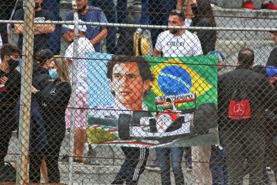 Circuit atmosphere - banner for Ayrton Senna with fans in the