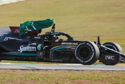 Race winner Lewis Hamilton (GBR) Mercedes AMG F1 W12 celebrates carrying the Brazilian flag at the end of the