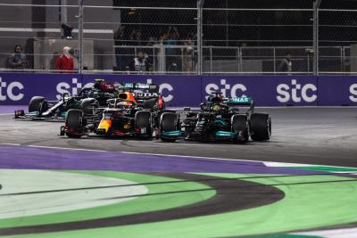 Lewis Hamilton (GBR) Mercedes AMG F1 W12 and Max Verstappen (NLD) Red Bull Racing RB16B battle for the lead at the first