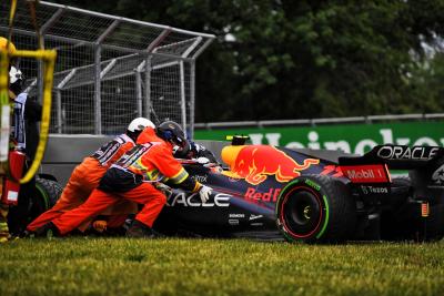 The Red Bull Racing RB18 of Sergio Perez (MEX) Red Bull Racing is recovered after he crashed during qualifying. Formula 1