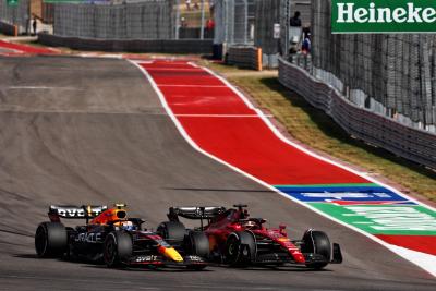 Sergio Perez (MEX) Red Bull Racing RB18 and Charles Leclerc (MON) Ferrari F1-75 battle for position. Formula 1 World
