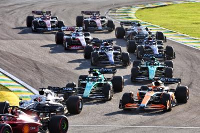 Sebastian Vettel (GER) Aston Martin F1 Team AMR22 and Daniel Ricciardo (AUS) McLaren MCL36 at the start of the race.