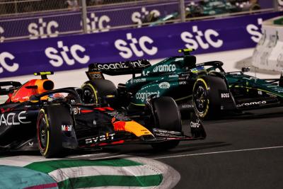 Sergio Perez (MEX) Red Bull Racing RB19 and Fernando Alonso (ESP) Aston Martin F1 Team AMR23 battle for the lead of the