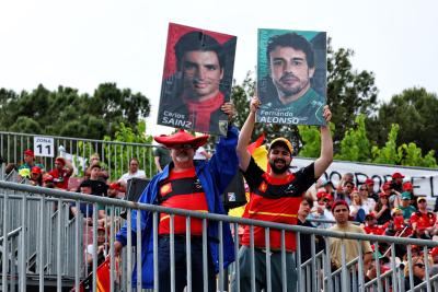 Circuit atmosphere - Carlos Sainz Jr (ESP) Ferrari and Fernando Alonso (ESP) Aston Martin F1 Team fans in the grandstand.