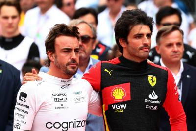 (L to R): Fernando Alonso (ESP) Aston Martin F1 Team and Carlos Sainz Jr (ESP) Ferrari as the grid observes the national