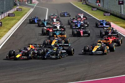 Max Verstappen (NLD) Red Bull Racing RB19 leads Lewis Hamilton (GBR) Mercedes AMG F1 W14 at the start of the race. Formula