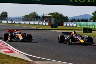 Oscar Piastri (AUS) McLaren MCL60 and Sergio Perez (MEX) Red Bull Racing RB19 battle for position. Formula 1 World