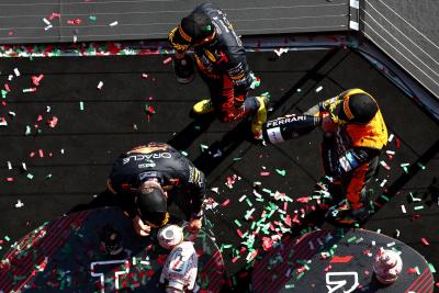 Max Verstappen (NLD) Red Bull Racing retrieves his broken trophy on the podium with Sergio Perez (MEX) Red Bull Racing and