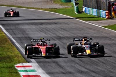 Max Verstappen (NLD) Red Bull Racing RB19 passes Carlos Sainz Jr (ESP) Ferrari SF-23 to lead the race. Formula 1 World