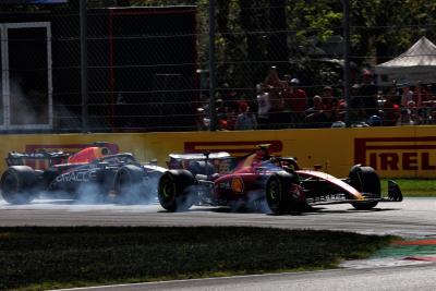 Carlos Sainz Jr (ESP) Ferrari SF-23 locks up under braking ahead of Max Verstappen (NLD) Red Bull Racing RB19. Formula 1
