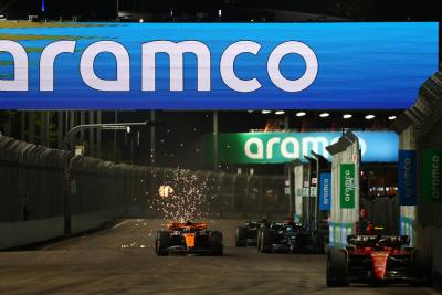 Carlos Sainz Jr (ESP) Ferrari SF-23 leads Lando Norris (GBR) McLaren MCL60 and George Russell (GBR) Mercedes AMG F1 W14.