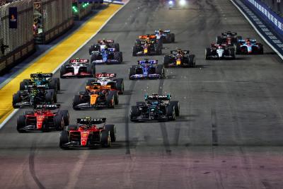 Carlos Sainz Jr (ESP) Ferrari SF-23 leads at the start of the race. Formula 1 World Championship, Rd 16, Singapore Grand