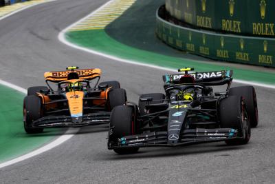 Lewis Hamilton (GBR) Mercedes AMG F1 W14 and Lando Norris (GBR) McLaren MCL60 leave the pits. Formula 1 World