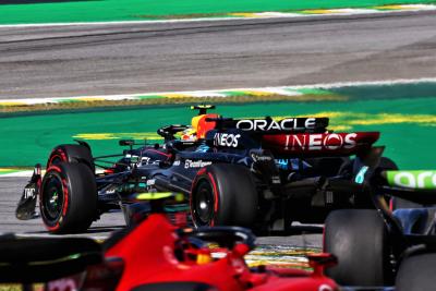 Sergio Perez (MEX) Red Bull Racing RB19 leads George Russell (GBR) Mercedes AMG F1 W14. Formula 1 World Championship, Rd